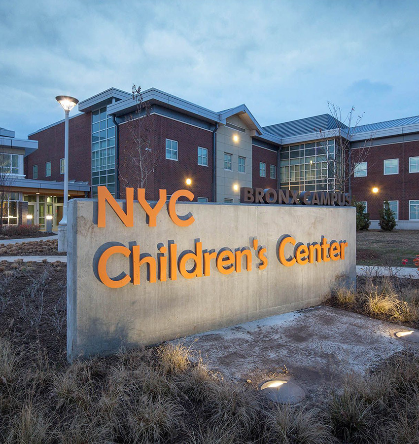 Brick building, NYC Childrens Center Bronx Campus sign, grassy area.