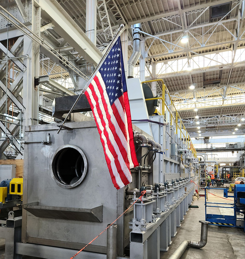 American flag on industrial machine in a bright factory.