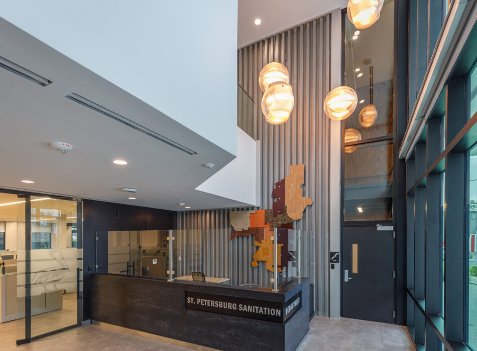 Lobby with St. Petersburg Sanitation desk, glass walls, art.