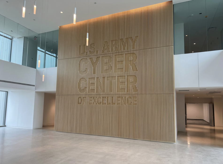 Modern lobby with wooden wall reading Army Cyber Center.