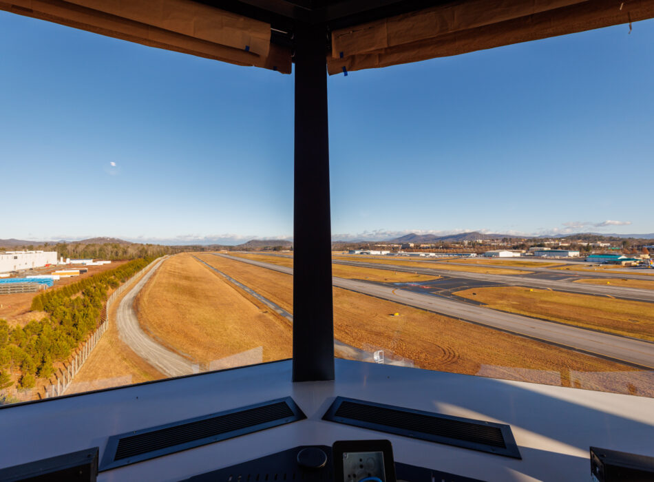 Airport control tower view of runways on a sunny day.
