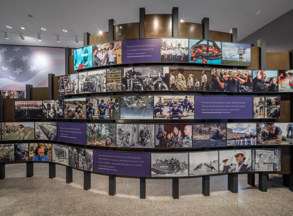 Curved wall with historic photos, info panels, and flag mural.