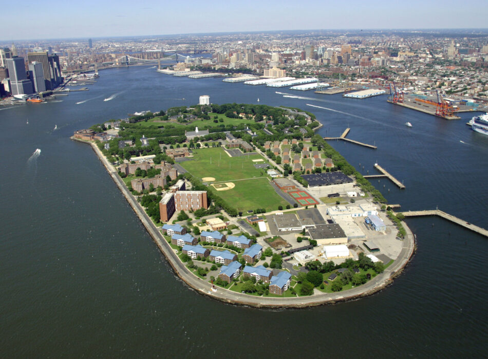Governors Island with parks and docks, Manhattan in background.