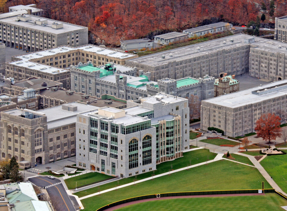 Aerial view of gray stone campus with green roofs.